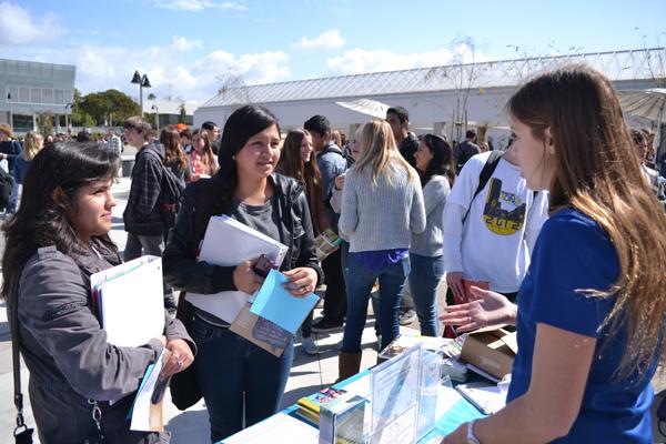 Students speak to college representatives at the mini-college fair held Thursday, Feb. 21, at lunch. Many colleges as well as the military were in the Plaza to help students consider their post-high school college and career plans.