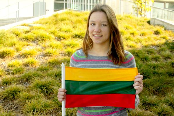 Gabija Grigonyte poses with the Lithuanian flag. Grigonyte was born in Lithuania, a country near Poland and Latvia, but moved to the United States when she was four years old.