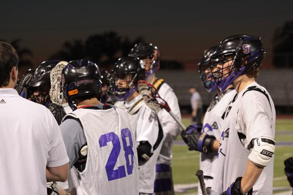 The varsity lacrosse team discusses their game plan against Cathedral Catholic. They put up a good fight, but wound up losing 12-5.