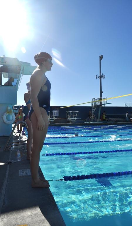 Sophomore Nicole Graber prepares before a jump into the cool water of the CHS swim complex. This past week the JV and varsity teams have been conditioning for their upcoming time trials.