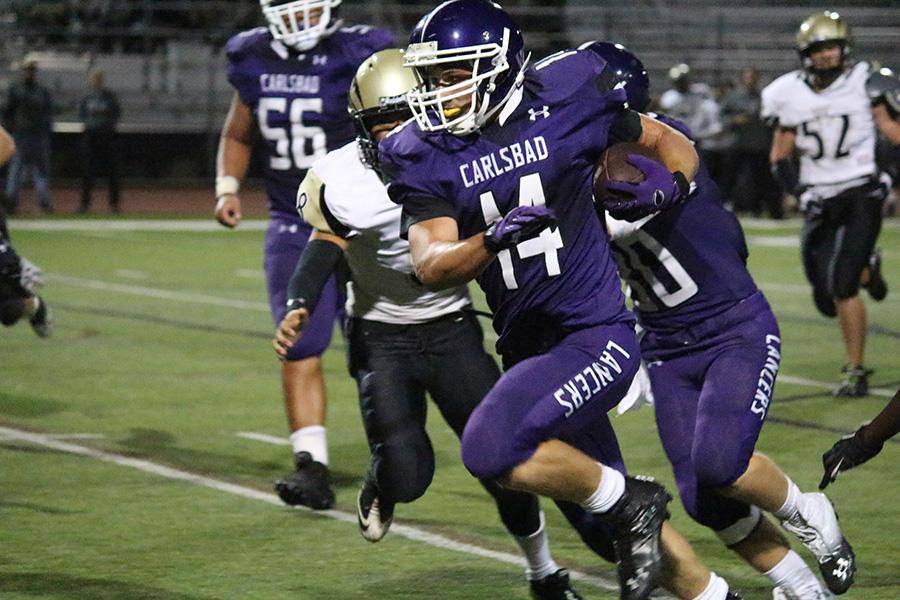 Holland Crider scores his first touchdown as a Lancer at the Homecoming game. Typically, Holland plays defense but with his return to Carlsbad hes proved his talent as a player.