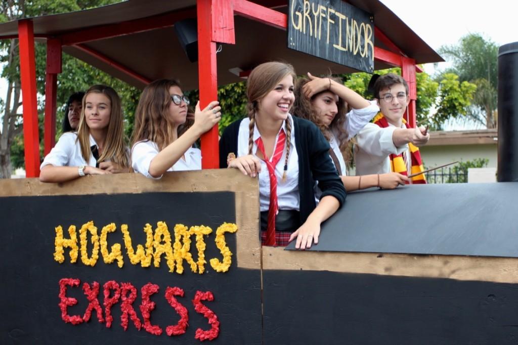 CHS seniors ride the Hogwarts Express during the annual Lancer Day Parade. Decked out in Harry Potter gear, these students wear red and gold to represent Gryffindor. 
