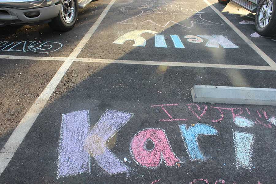 Seniors use chalk to write their names and reserve spots all throughout the parking lot.  Throughout the course of the day, some were smeared, but students were quick to fill them back in.