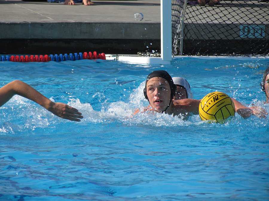 Receiving a pass from his teammate, Daniel swims down the pool to start a Lancer offensive. Transition offense played a big role against the Eagles.
