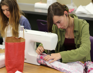 Fashion student Natalie Forbess goes to work on her sewing machine. These fashion students work hard in the chance of gaining a scholarship to college.
