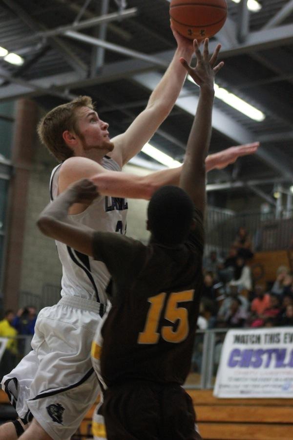 Senior Chase Ogden scores during Fridays basketball game against El Camino. Although the Lancers suffered a loss, the team still maintains an outstanding season record.