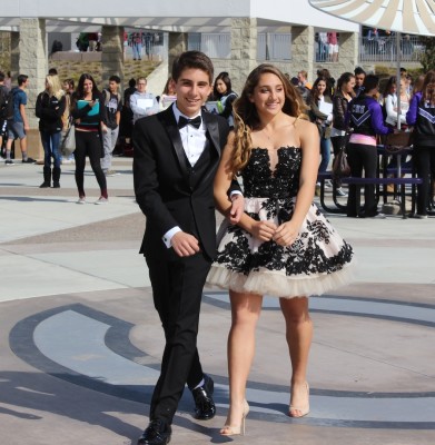 Freshmen Noah Nasser and Alexis Mertz model their formal attire at the pep rally on Friday. Students in ASB put together a fashion show to give students an idea of what to wear to formal March 1st. 