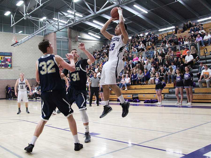 Senior forward Matthew Tomaneng scores for the Lancers in the first quarter of Friday nights basketball game against La Costa Canyon. Despite the Lancers best effort, they suffered a loss against the highly ranked team with a final score of 60-43.