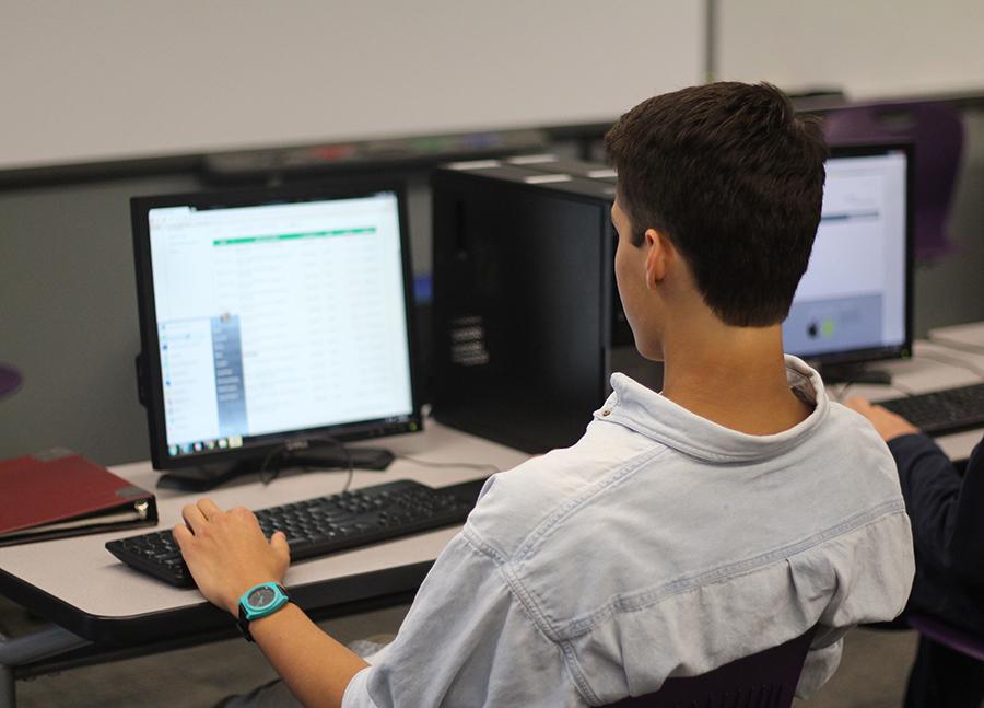 Student Micah Johnson devotes class time to checking his business bank account. In Virtual Enterprise, the students have an opportunity to create and manage their own businesses throughout the year. 
