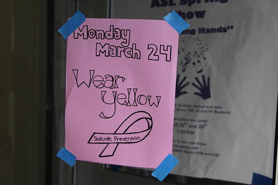 A poster hangs outside the 3000 building reminding students to participate in Yellow Ribbon Week. Yellow Ribbon Week was put in place to raise suicide awareness. 