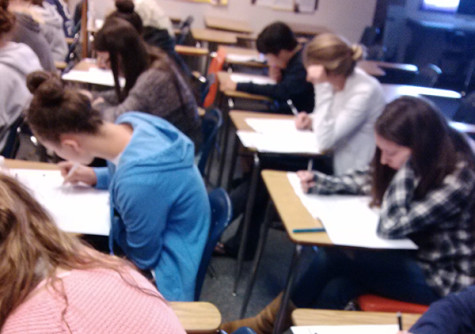 Students focus in on their English 3AP mock test. The test includes a 60 minute multiple choice section and a two hour and fifteen minute essay period. 