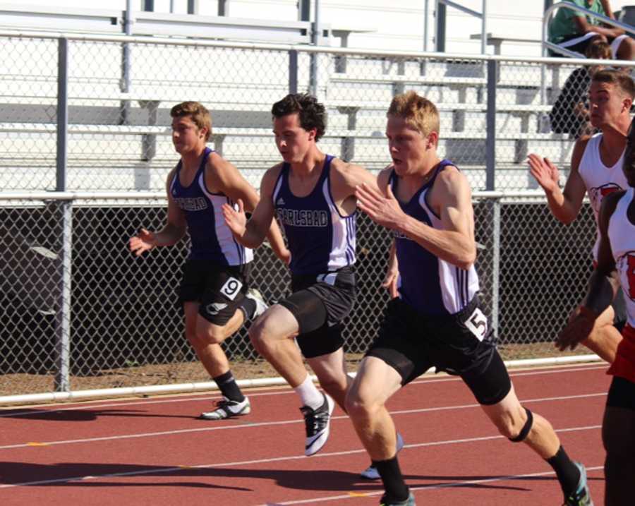 From right to left, Chris Spiering (11), Drew Derrickson (11), and Paolo LoMedico (11) run the 100m dash. Carlsbad  dominated and beat Fallbrook in the meet on Thursday. 
