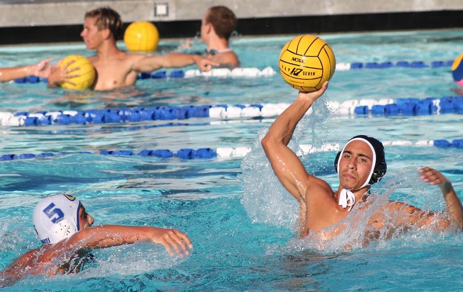 Senior Connor Chanove prepares to pass the ball to one of his teammates during the water polo games.  The team took on Grossmont High and won 10-3.