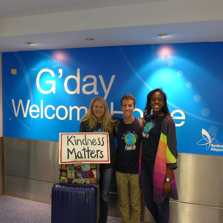 Fresh off the plane, Grady, Jill and Adoley take a moment to represent the World Kindness Movement at the airport. 