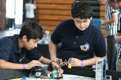 Two members of the Valley Robotics Club set up their  robot in preperation for their event. On Sat. 15, 2014 Carlsbad High Schools own Robotics club hosted a robotics competition for local schools.
