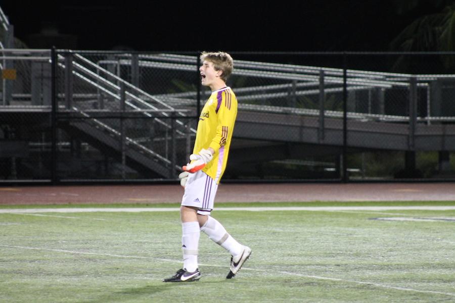 Seth Ketterer, mens varsity soccer goalkeeper, cheers on his teammates during the game against fallbrook.  This is Seths first year on the team.