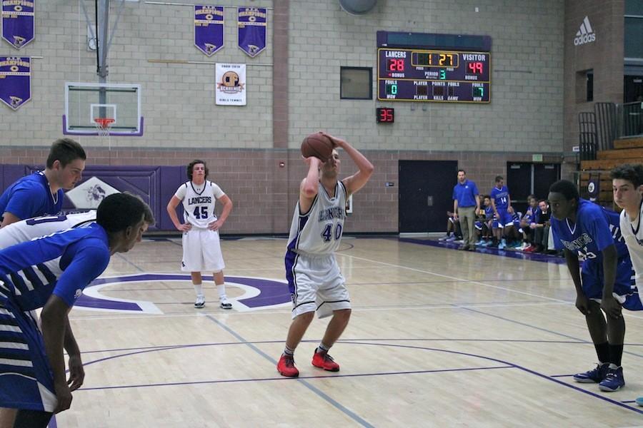 Senior Matt Muilenburg shoots on a free throw. Though the team fought valiantly, they lost to 42-75. 
