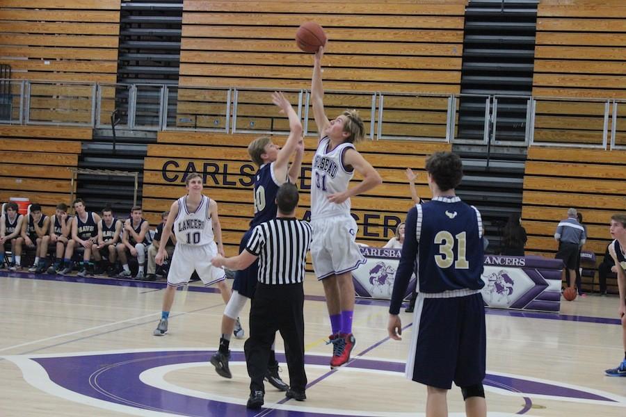 Carlsbad JV basketball player wins the starting jump ball against LCC. Carlsbad put up a strong fight eventually taking down the Mavericks 55-52. 