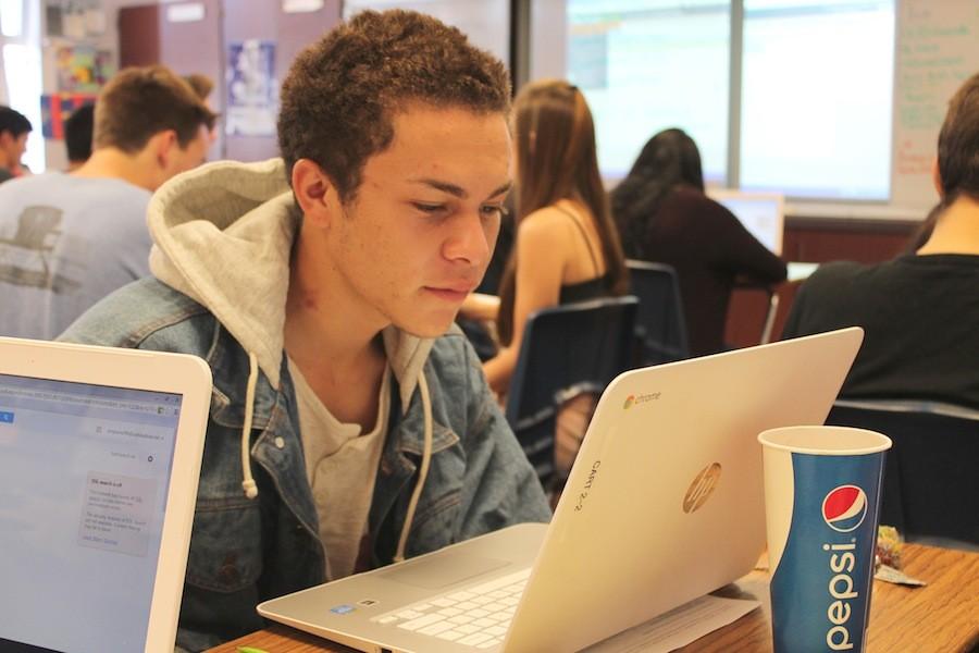 Senior Quentin Reynoso works on computers during Mrs.Brittons english class. Many english teachers are incorporating new technology into there curriculum. 