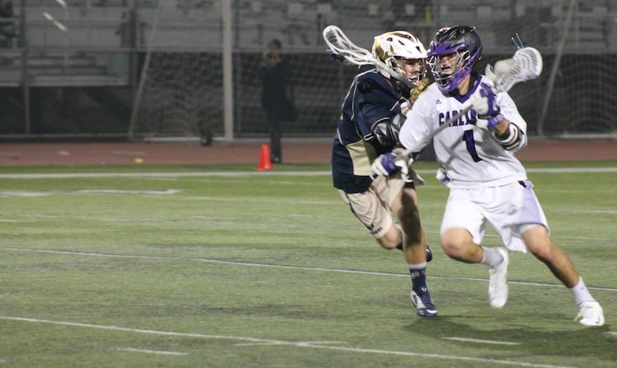 Sophomore Jake Keller dodges the defender during a game against La Costa Canyon High School on March 10,2015. The team fought valiantly;however, Carlsbad lost 3-7.