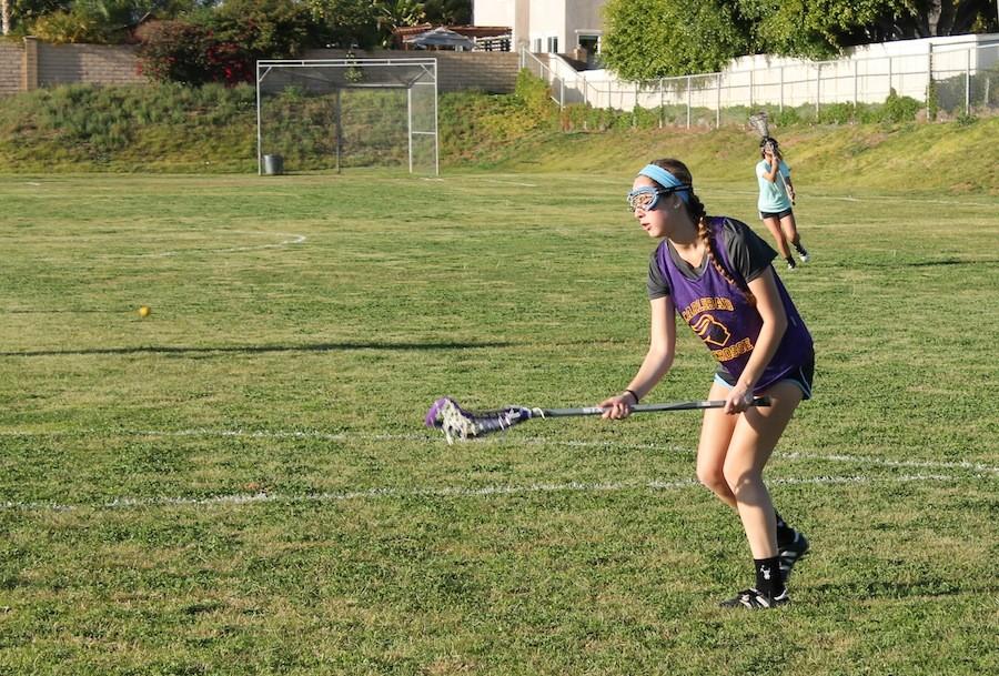 Senior Alex Gardner warms up during lacrosse  practice.  Gardner also has been playing soccer for thirteen years.