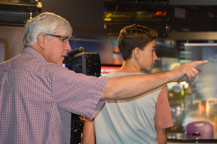 Mr. Green helps freshman, Jacob Idris learn to work the camera before the opening on their live show. Mr. Green was awarded the San Diego County teacher of the year and is up for the state of Californias teacher of the year.  