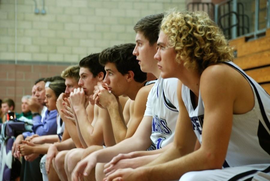 Members of the Carlsbad basketball team watch Wednesdays tough loss against Poway. The Lancers bounced back on Friday after winning the White Out game against Orange Glen. 