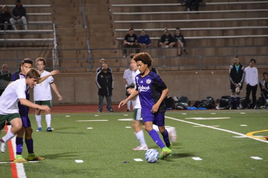 Junior, Kyle Lawrence, drives the ball towards the goal in their game against LCC on Thurs, Feb 18. Carlsbad came up short, the score coming to 0-3.