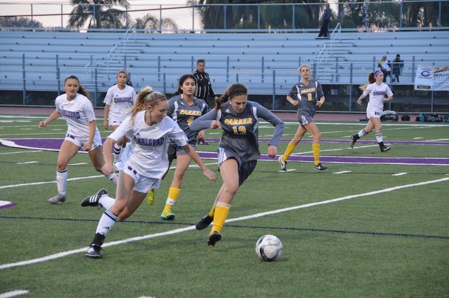 Freshman, Avery Shaffer, takes the ball towards the goal in their game against Parker High School on  Tues. Feb. 23. Lancers got the win, the score coming to 4-0.