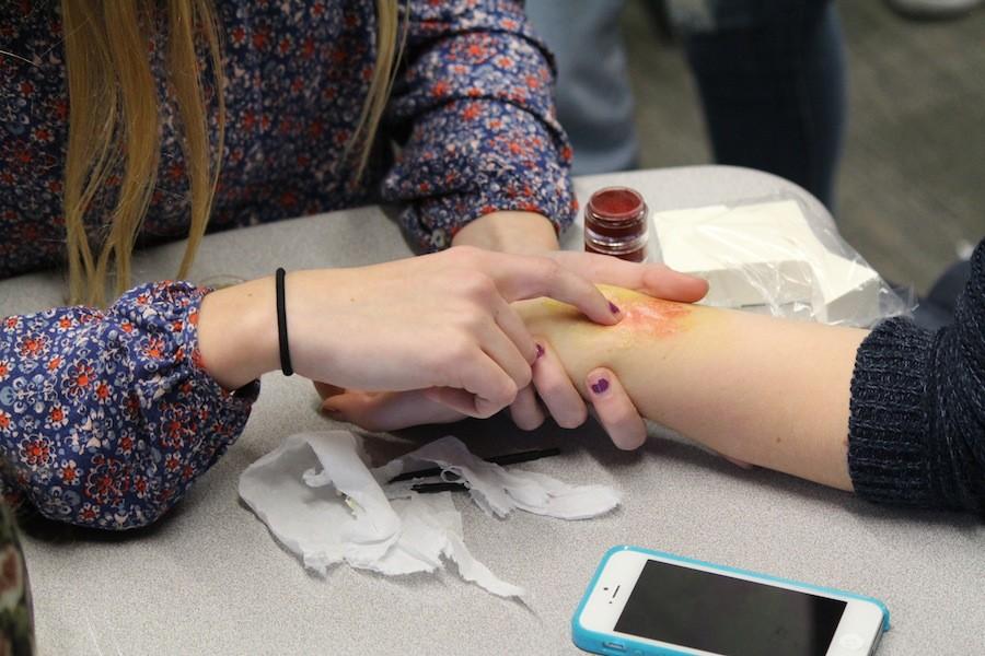 After only a few meetings, special effects club gets their hands on some makeup. Tatum provides everyone with makeup and plates to have play around with it. She gives a lesson on how to make a wound. As she walks around, she gives tips and helps a few people make their wounds. 