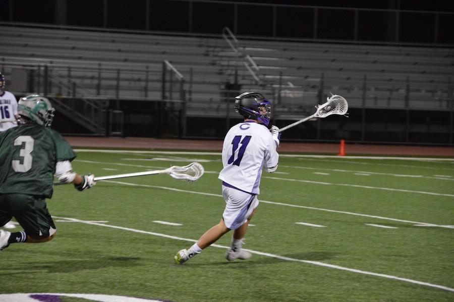 Senior, Ty Funderburk, turns to pass the ball to his teammate for a chance to score. The Lancers fall short against Poway on Fri, Mar. 4, the score coming to 5-14, Poway. 