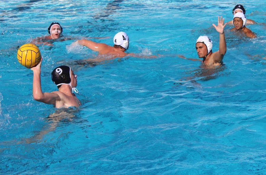 #9 Graham Asalone (11) winds up for a shot against the opposing defenders. On Fri. Sep. 9 Carlsbads varsity boys water polo played La Serna High School for their first game of the season, coming out with a win 12-6.