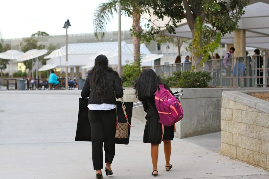 Competitors carry expository boards and their supplies, walking to their next round. Sat., Oct. 16, CHS hosted a speech and debate tournament for the San Diego area.