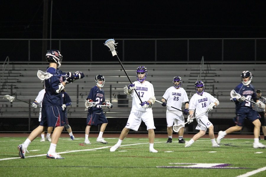 Freshman, Edward Gardener plays strong defense against his attacker. On Tuesday, March 7th, the Carlsbad boys lacrosse team played Scipps ranch. The Falcons put up a strong fight but ended up losing to the Lancers 9-7.