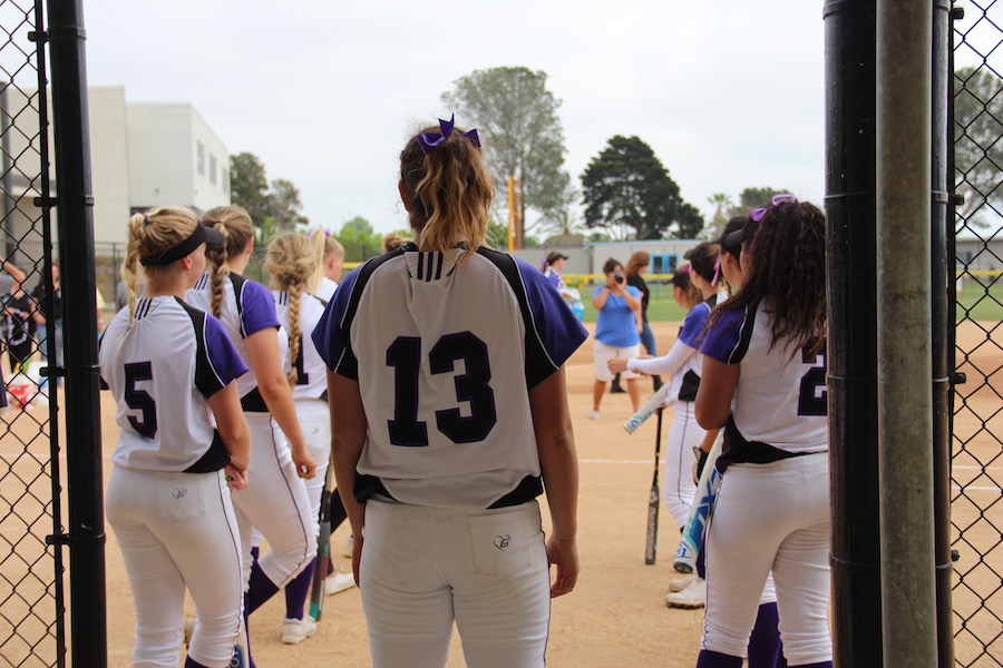 Number 13, Sarah Schneider waits for her turn as the seniors are announced on the loud speaker during their home game/Senior night on May 3.
