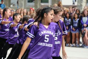 Senior, Maya Wong, and sophomore, Nicole Burke, dance during the USA game pep rally, Friday, Sept.  15. The Lancer Dancers work to hype up students for the game during the pep rally.