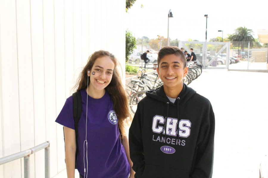 Junior Sierra Vakilli, and freshman Ravi Pathak, smile for the camera. The students exhibit confidence with their proud smiles and school spirit.