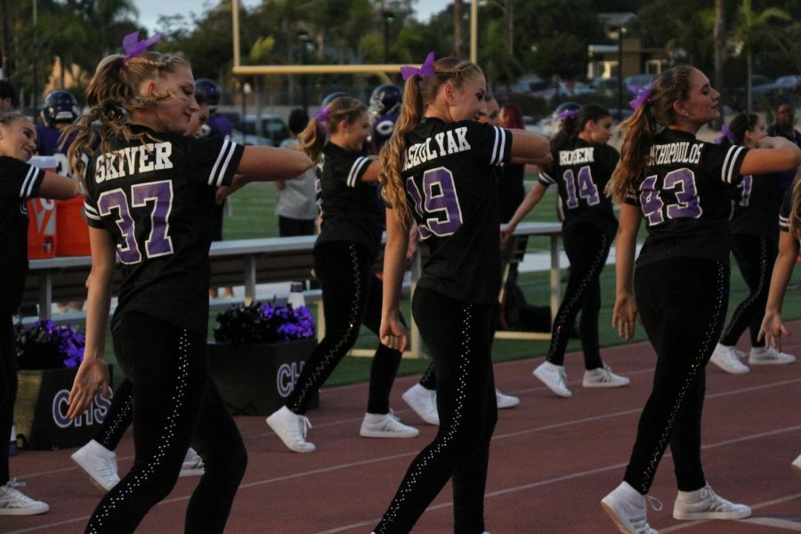 Freshman Olivia Skiver and sophomores Emily Kraszulyak and Victoria Hrisanthopoulos dance in between the third and fourth quarter of the JV football game, Friday, Oct. 20. Kraszulyak, Hrisanthopoulos and Skiver are member of the JV dance team, X-Calibur.

