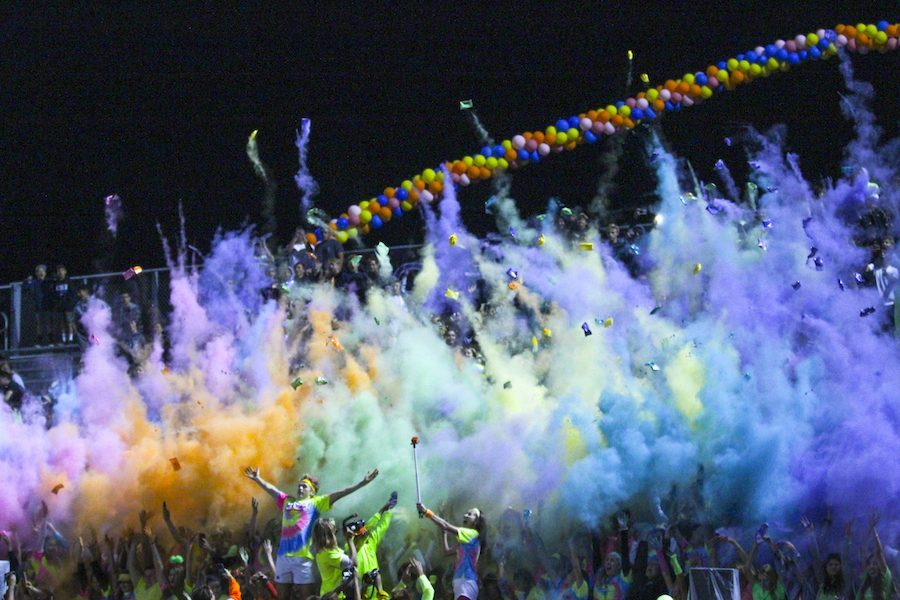 Loud+crowd+throws+neon+powder+up+to+celebrate+last+home+game.+Varsity+football+wins+their+last+home+game+before+CIF+finals+48-44.
