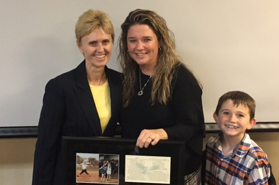 Athletic+director+Amanda+Waters+accepts+a+plaque+commemorating+her+entrance+into+the+Husson+University+Hall+of+Fame.+Waters+works+with+students+to+make+sure+they+are+succeeding+in+their+athletic+and+academic+lives.