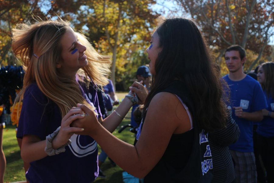 Junior Nicole Less and freshman Malia Paane dance together. There was a dance floor and DJ before and after the walk.