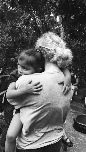 Junior Kaylin Kolb hugs a little girl from Nicaragua.