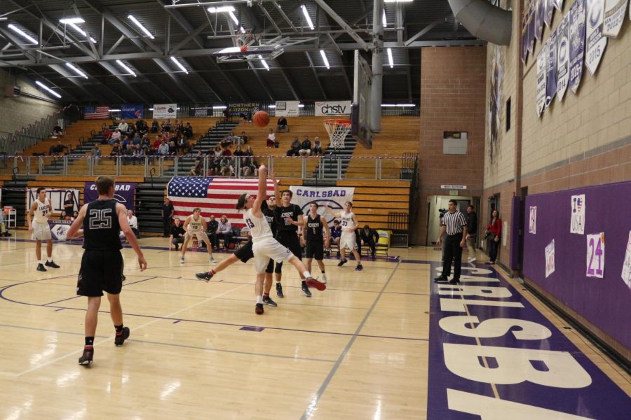 Junior Gavin Schmidt charges into the paint for two points. Carlsbad defeats CCA with a 61-59 victory.