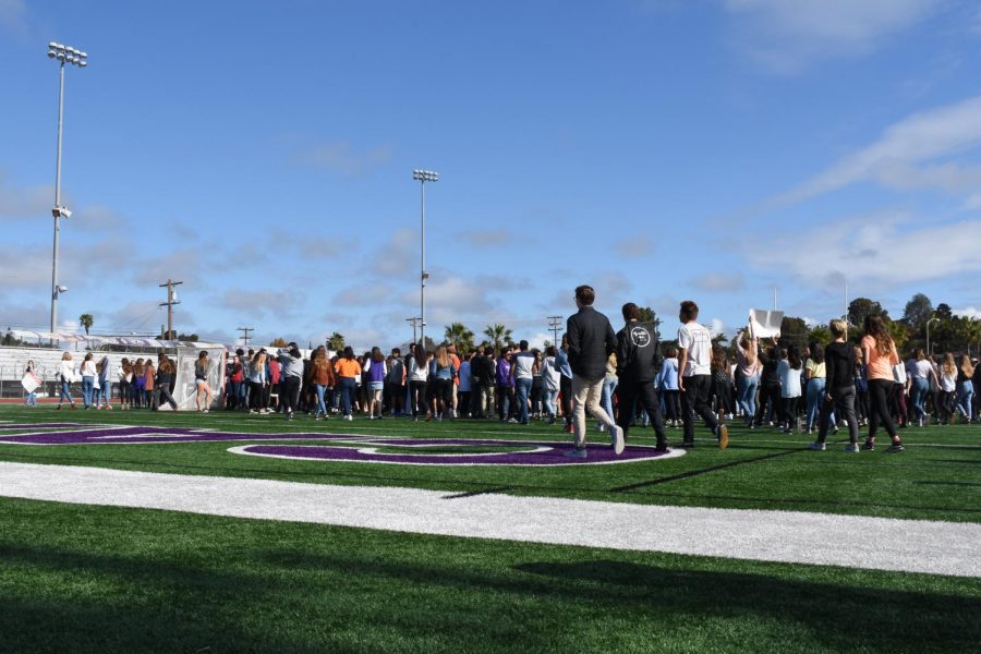 Students+walk+to+the+football+field+during+the+walkout+to+honor+the+victims+of+the+Florida+shooting.+Hundreds+of+students+participated+in+peaceful+protest.