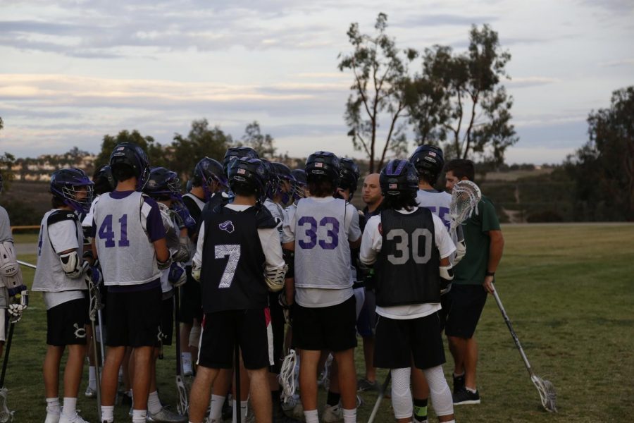 The lacrosse team huddles up for a pep talk from coach Dave Demuth. They hope to win the upcoming games in the near future.
