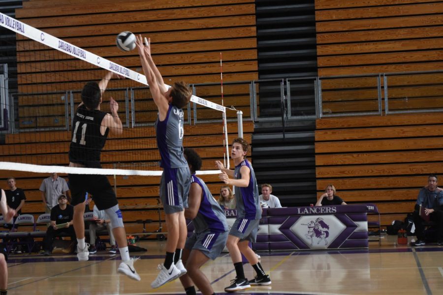 Senior Kaden Rutherford blocks a Pacific Ridge attempt to score a point. The Lancers won in three games over the Firebirds.