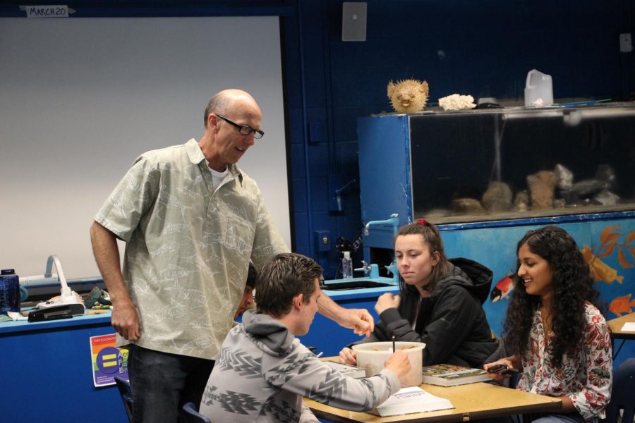Mr. Muilenburg won this years teacher of the year award. Muilenburg is seen here instructing students of his AP environmental class how to properly analyze a mortality chart. 