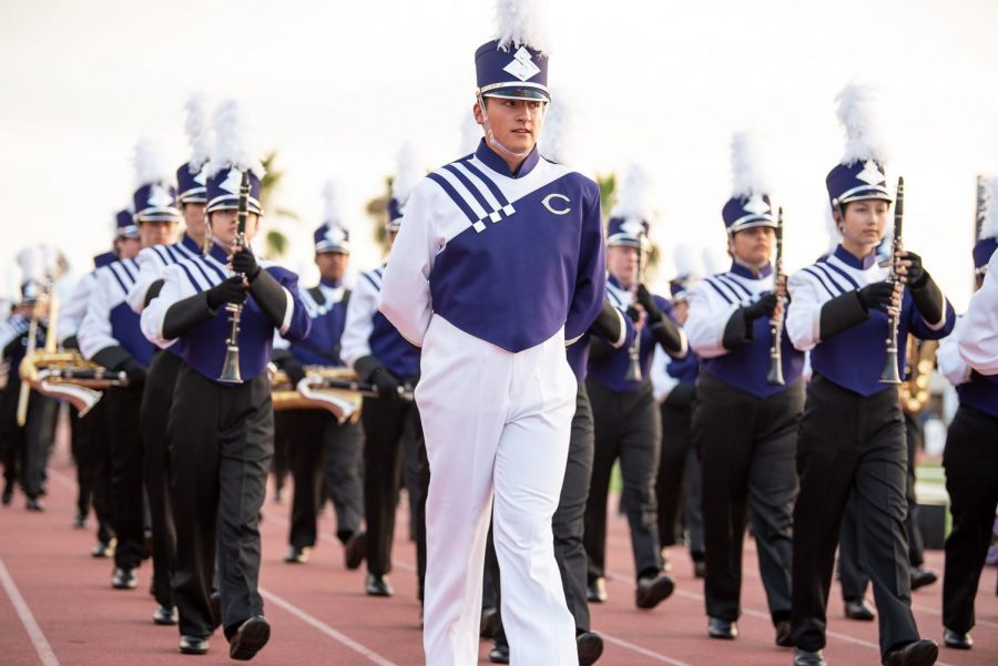 Ethan Prom, a band conductor at CHS, leads the band at different events and competitions.