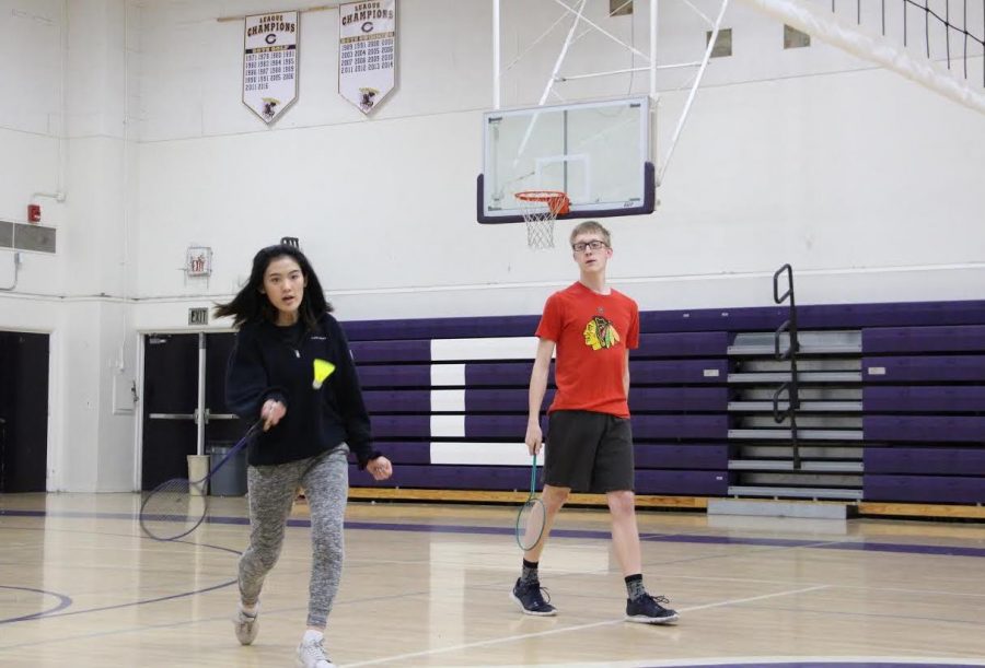 Juniors Alex Roberts and Sophia Zhao warm up with a quick rally at Badminton Club. The club regularly meets in the old gym to play badminton and have fun.