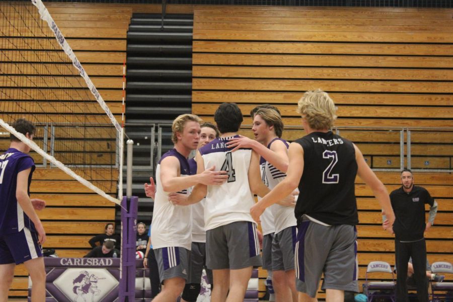 After scoring a point the team congratulates each other. They prepare for another set. 